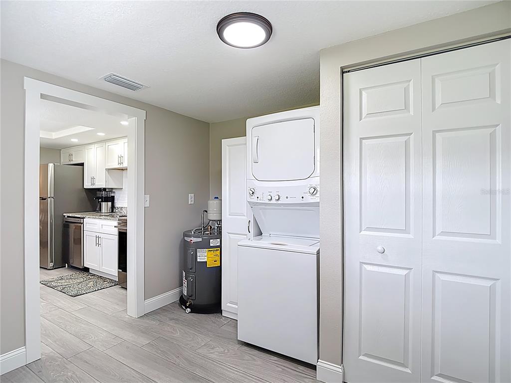 14306 Guava Street Hudson, FL 34667 - Photo 24 of 39 a storage room with washer and dryer