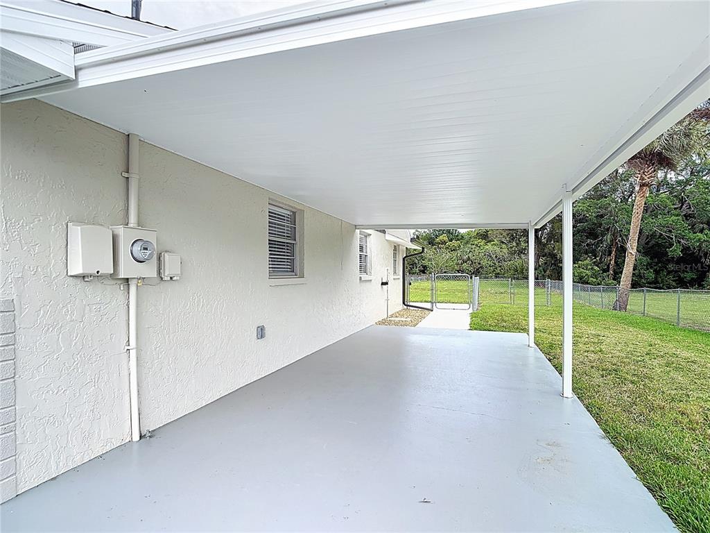 14306 Guava Street Hudson, FL 34667 - Photo 25 of 39 a view of a house with a backyard