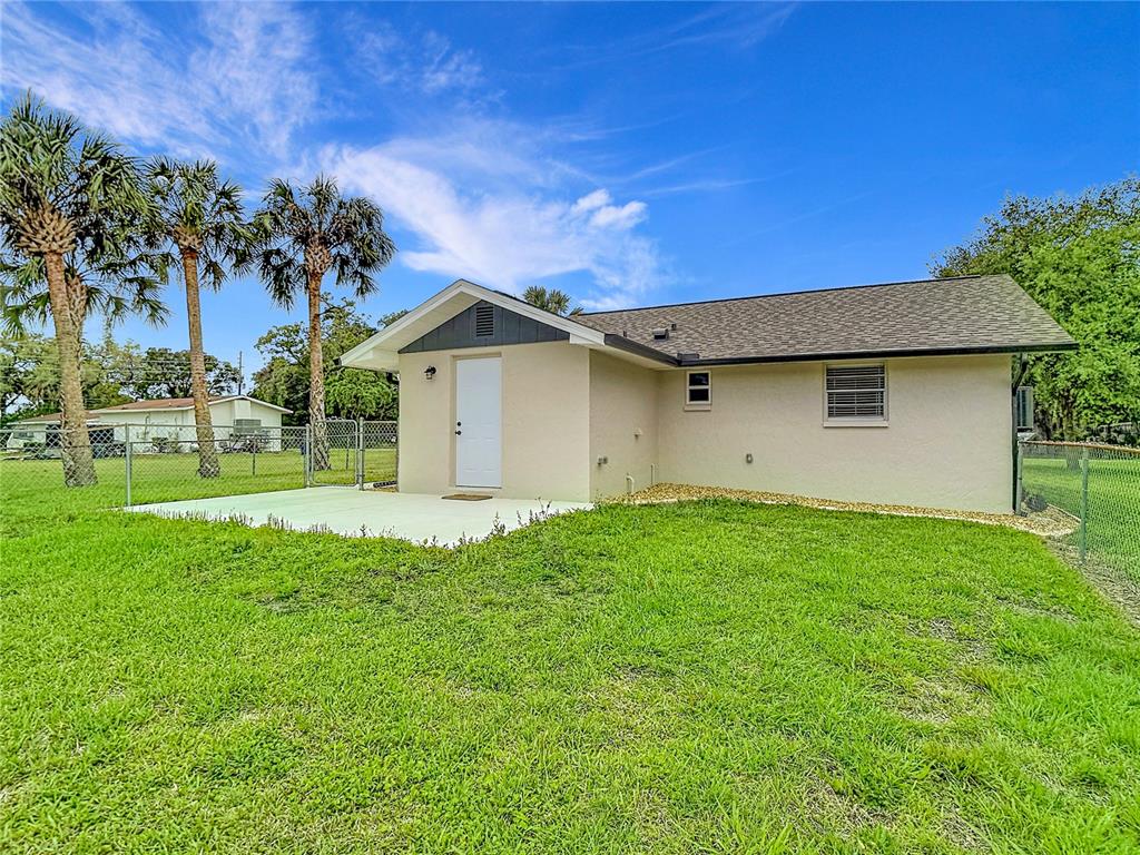 14306 Guava Street Hudson, FL 34667 - Photo 31 of 39 a view of backyard of house with green space