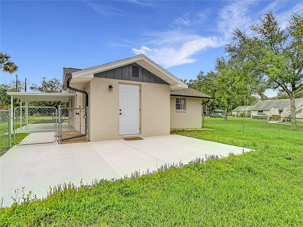 14306 Guava Street Hudson, FL 34667 - Photo 32 of 39 a house with yard in front of it