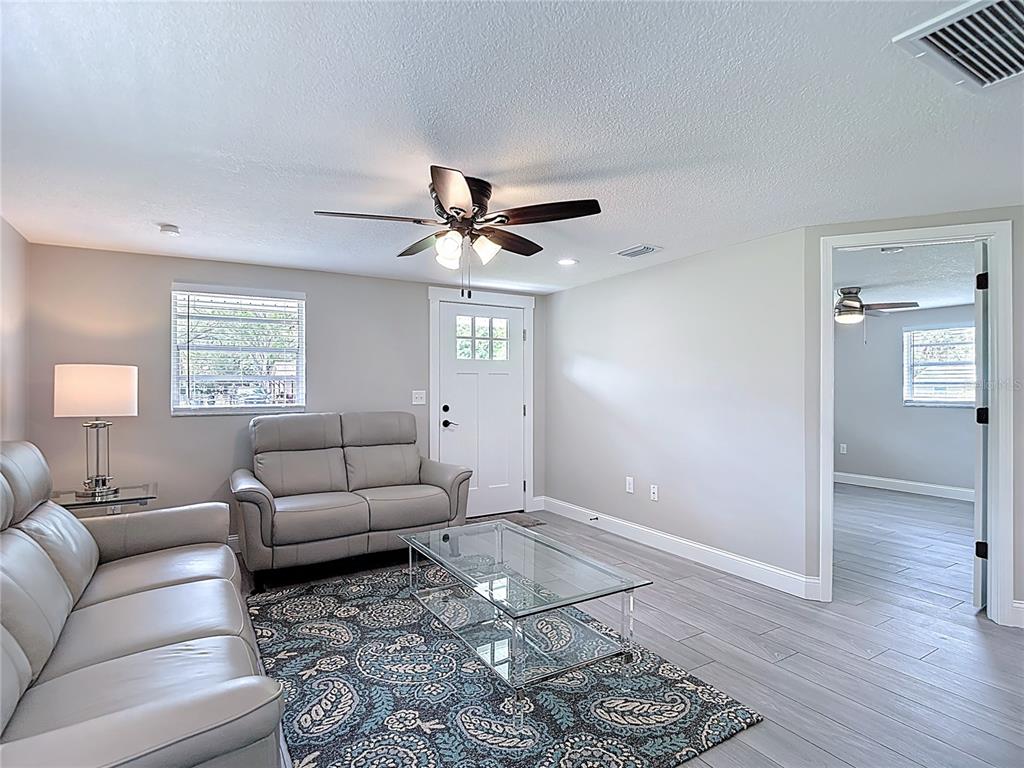 14306 Guava Street Hudson, FL 34667 - Photo 4 of 39 a living room with furniture and a window