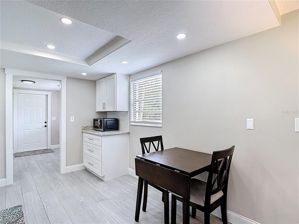 14306 Guava Street Hudson, FL 34667 - Photo 6 of 39 a kitchen with a table and chairs in it