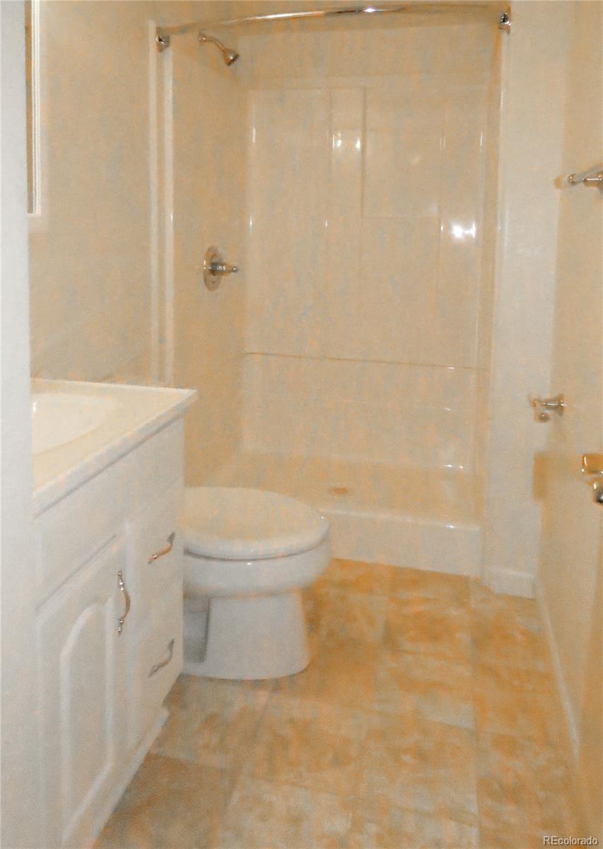 2141 Legacy Ridge View, Unit 101 Colorado Springs, CO 80910 - Photo 12 of 14 a bathroom with a toilet and a shower