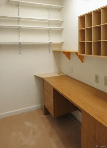 a view of a house with a wooden fence