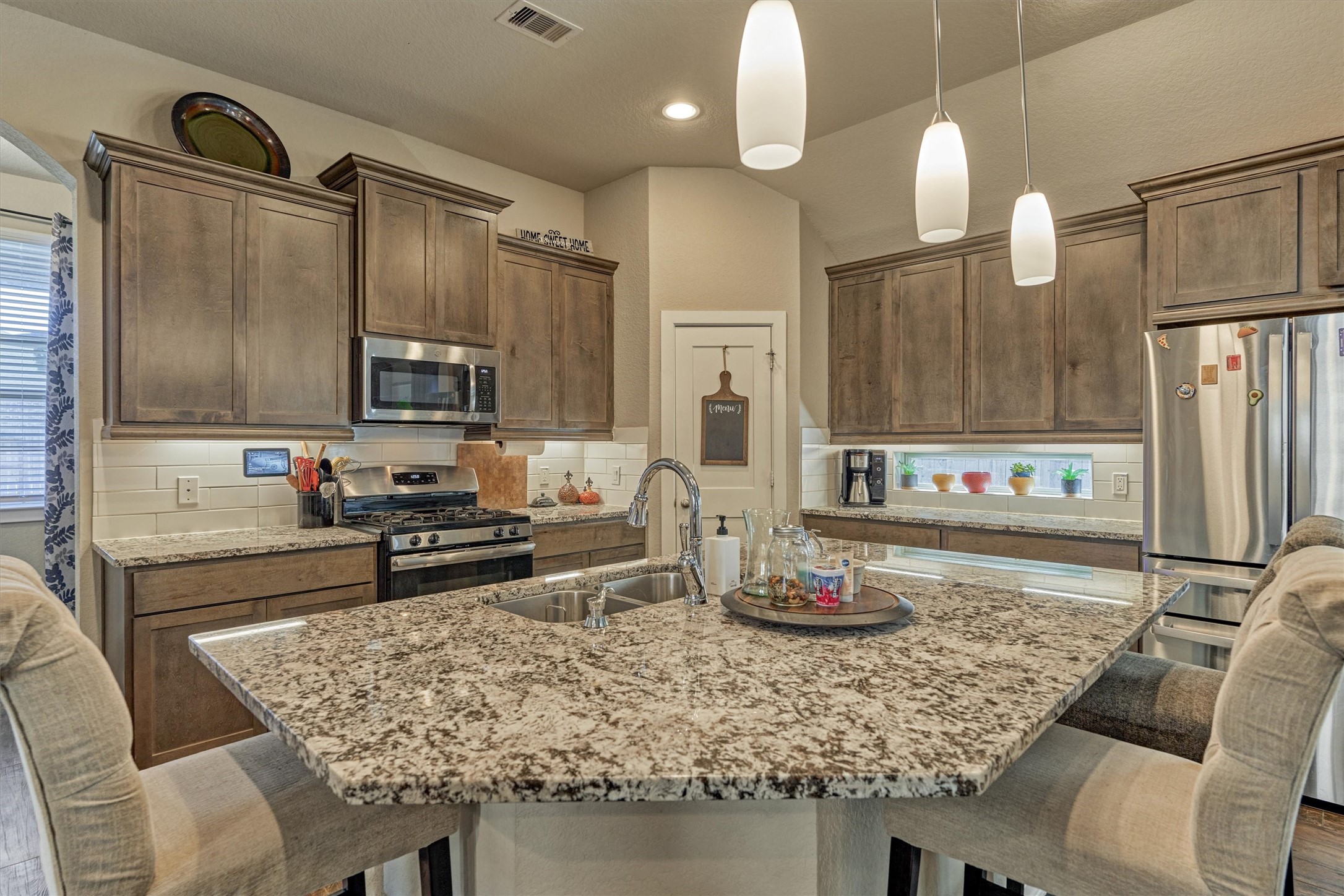 17015 Ash Leaf Way Conroe, TX 77385 - Photo 12 of 25 a kitchen with stainless steel appliances granite countertop a sink refrigerator and cabinets