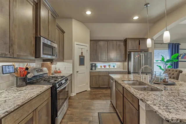 a view of a kitchen counter top space with furniture and a flat screen tv