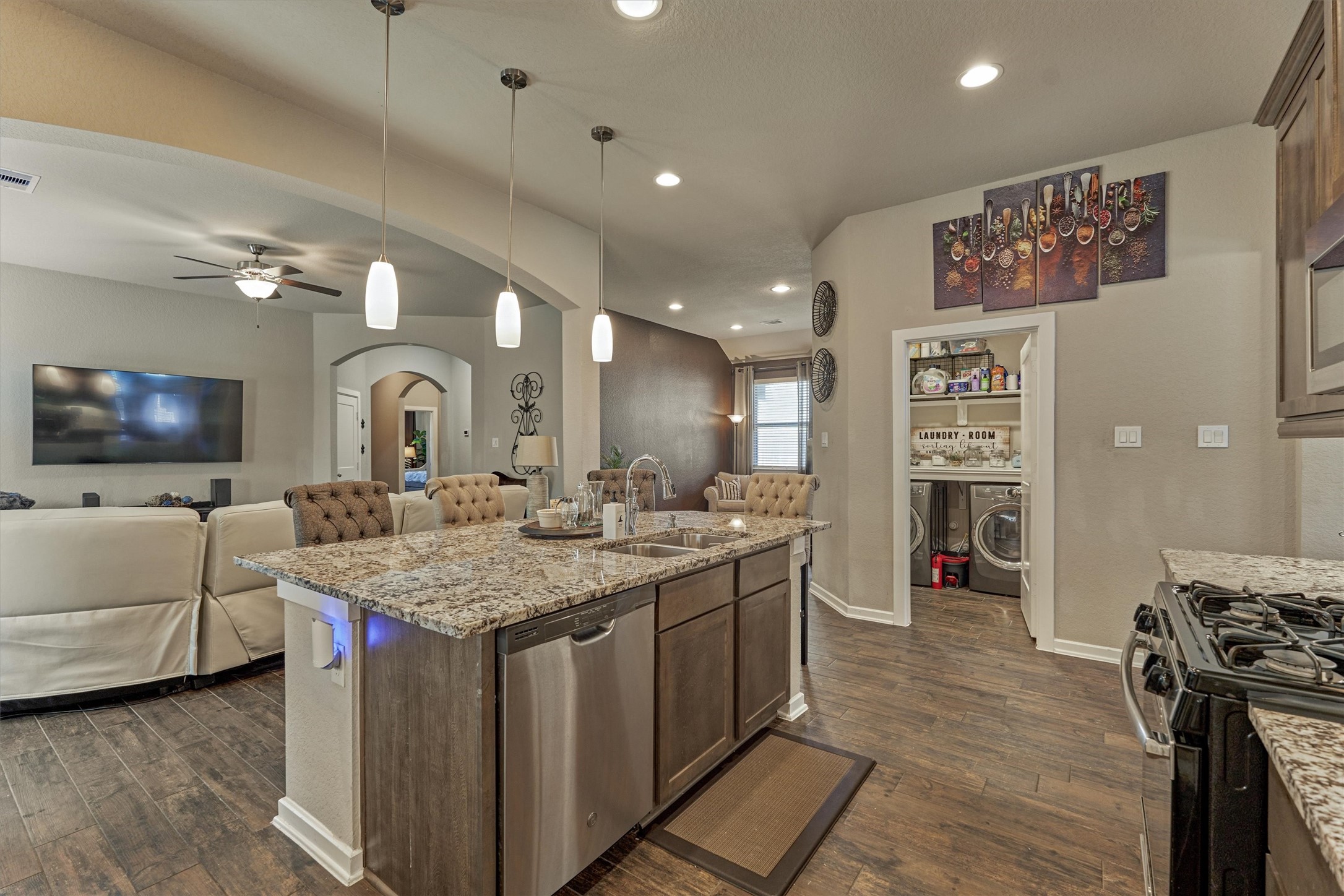 17015 Ash Leaf Way Conroe, TX 77385 - Photo 14 of 25 a view of a kitchen counter top space with furniture and a flat screen tv