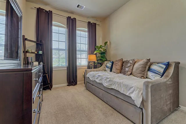 a large bedroom with a bed and furniture