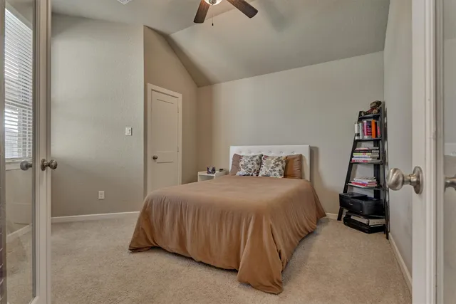 a bedroom with a bed couch and window