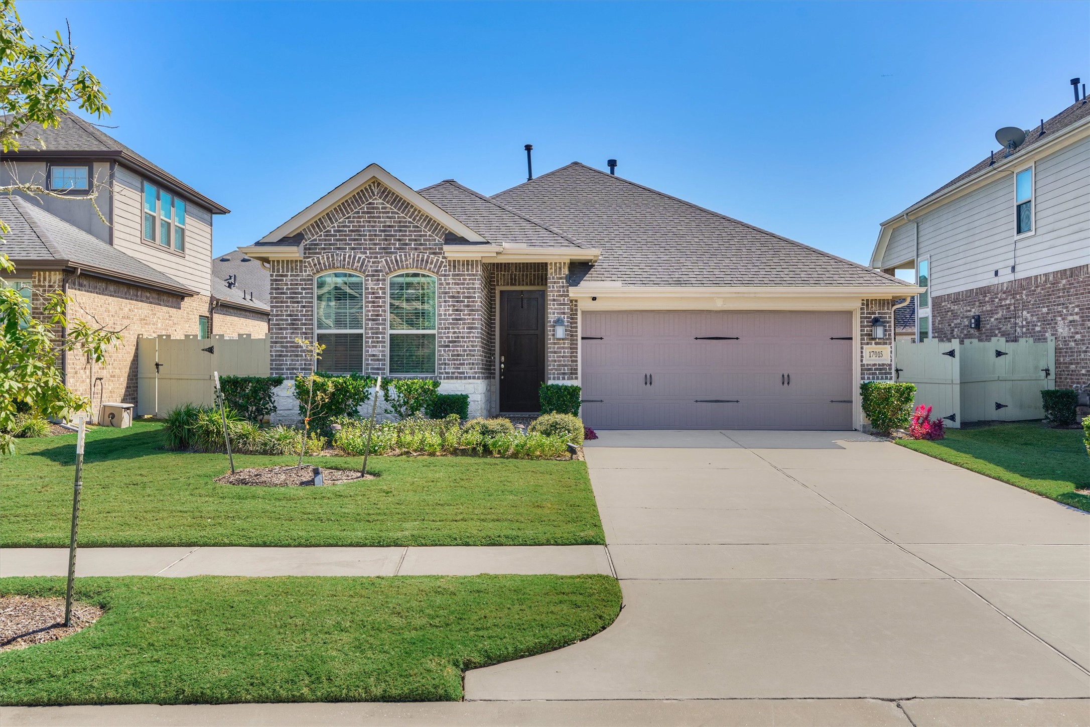17015 Ash Leaf Way Conroe, TX 77385 - Photo 2 of 25 a front view of a house with a yard and garage