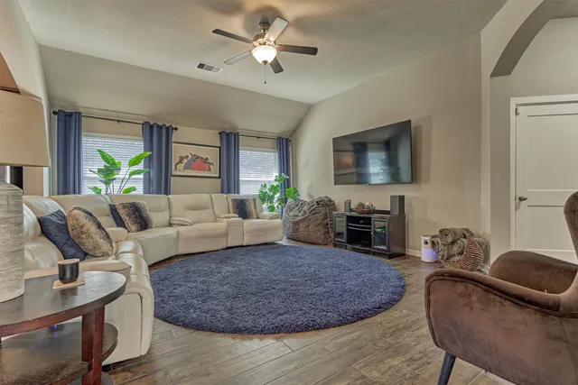 a living room with furniture a couch and a chandelier