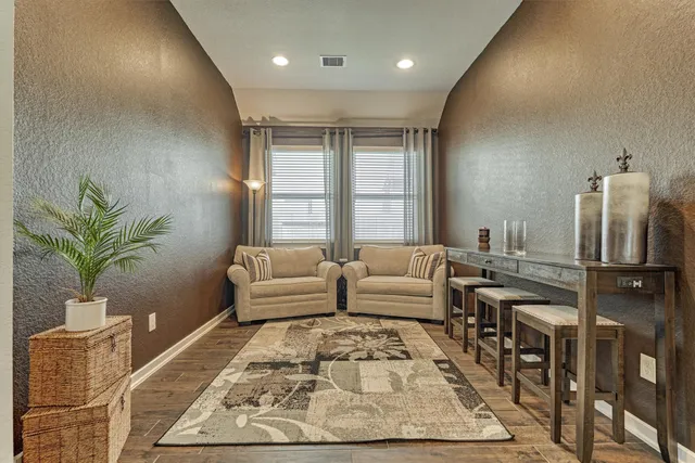 a living room with furniture and a dining table