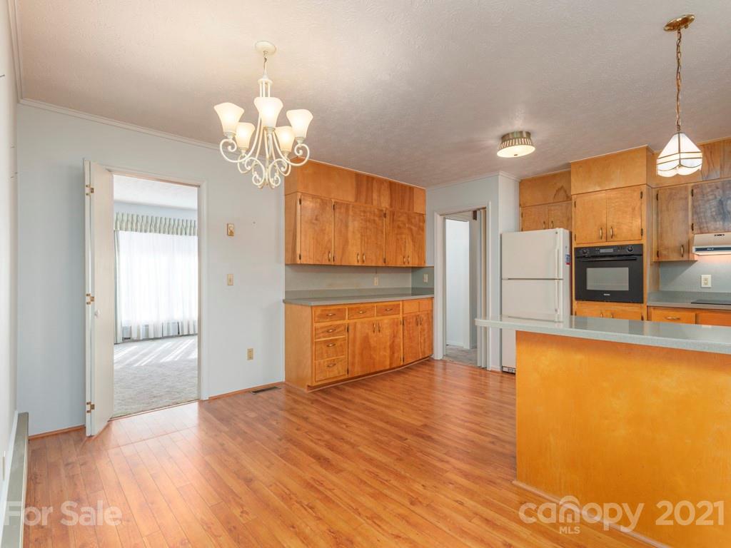 89 Pebblebrook Street Clyde, NC 28721 - Photo 3 of 17 a view of a kitchen with wooden floor and a refrigerator