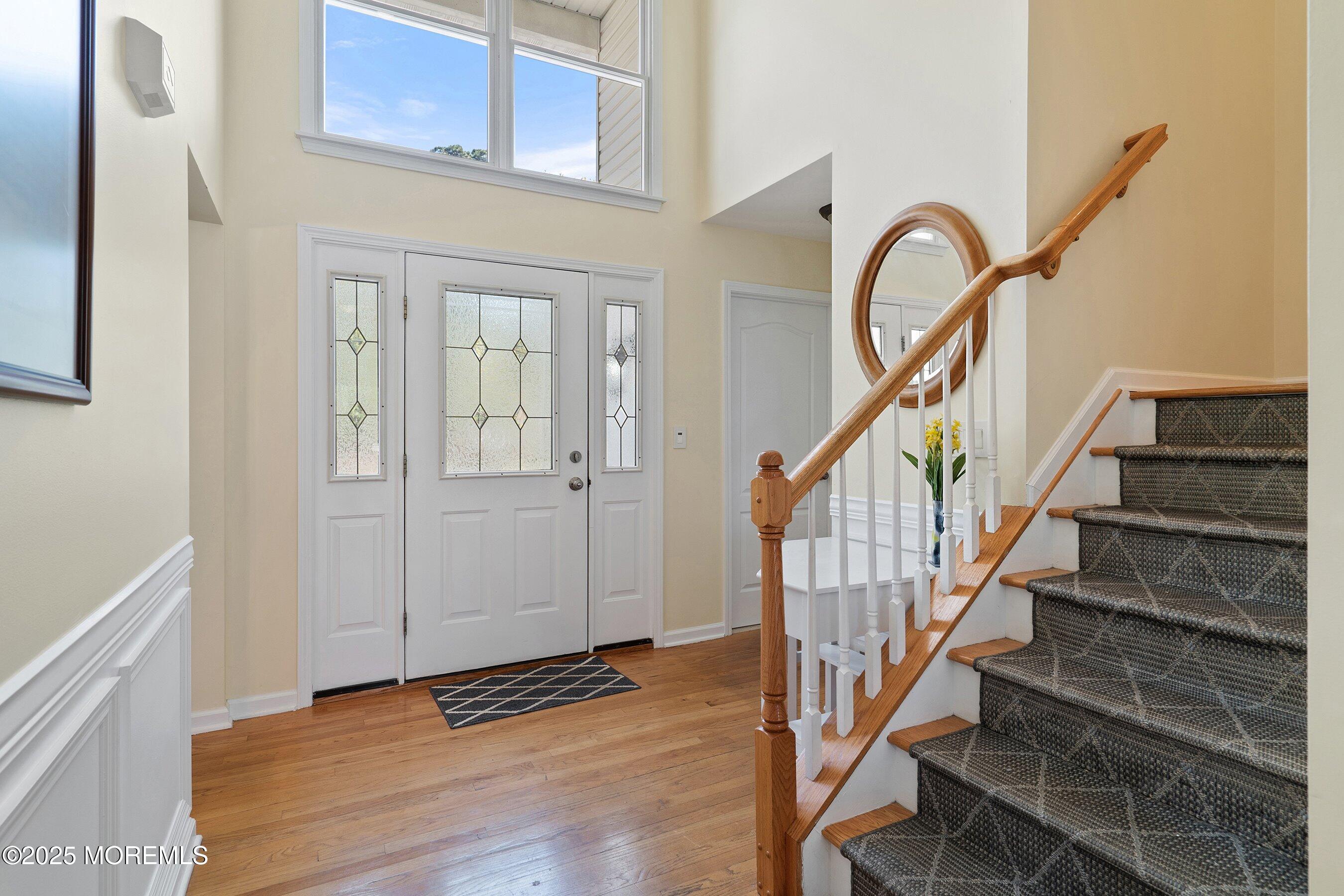 a view of entryway with wooden floor and stairs