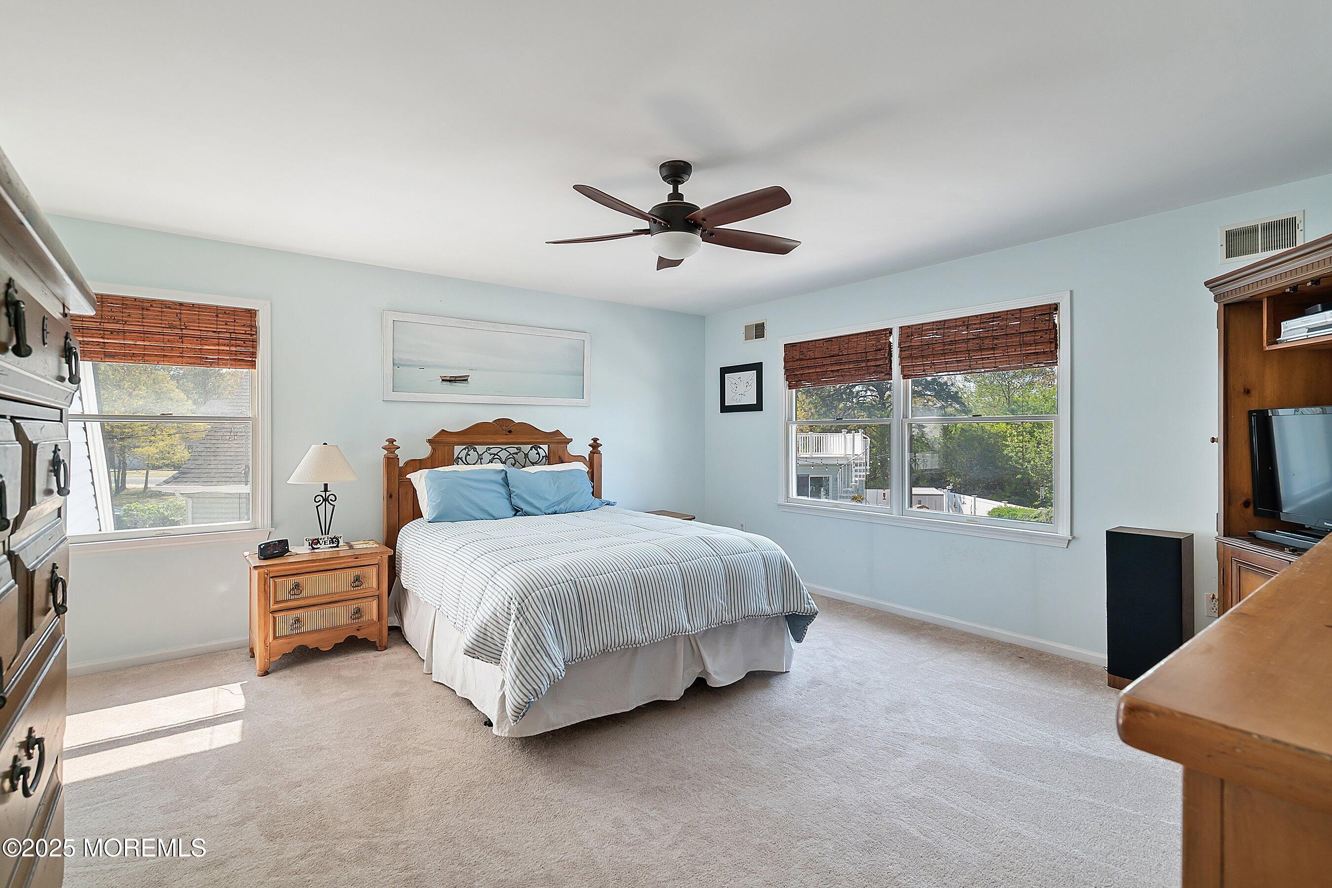 39 Ivy Court Bayville, NJ 08721 - Photo 13 of 33 a spacious bedroom with a bed and a large window