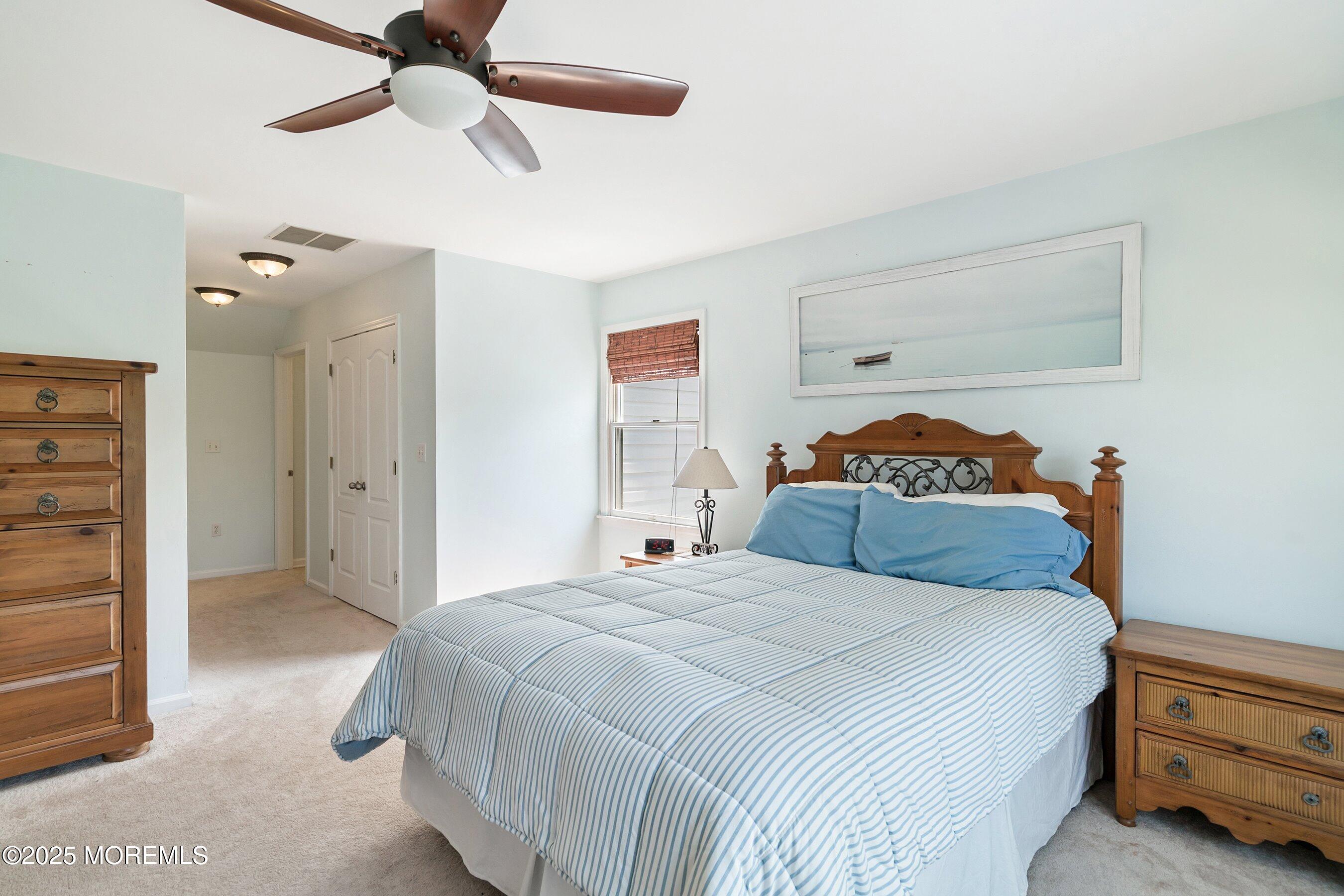 39 Ivy Court Bayville, NJ 08721 - Photo 14 of 33 a bedroom with a bed and a chandelier