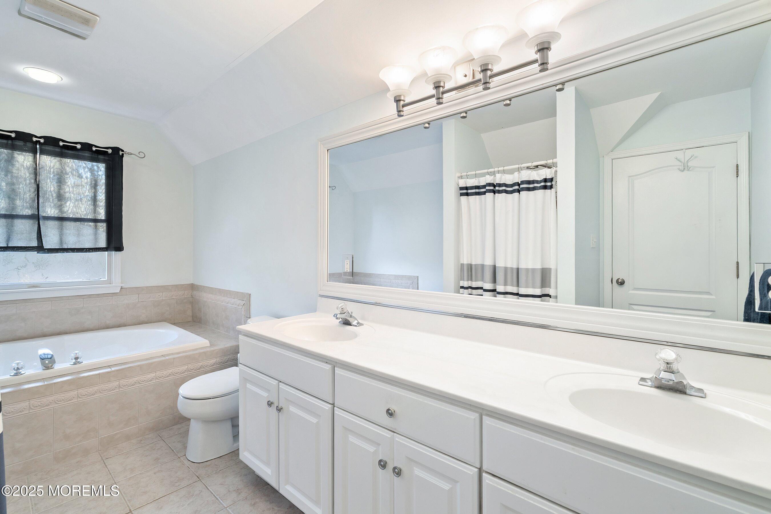 39 Ivy Court Bayville, NJ 08721 - Photo 15 of 33 a bathroom with a sink a toilet and a mirror