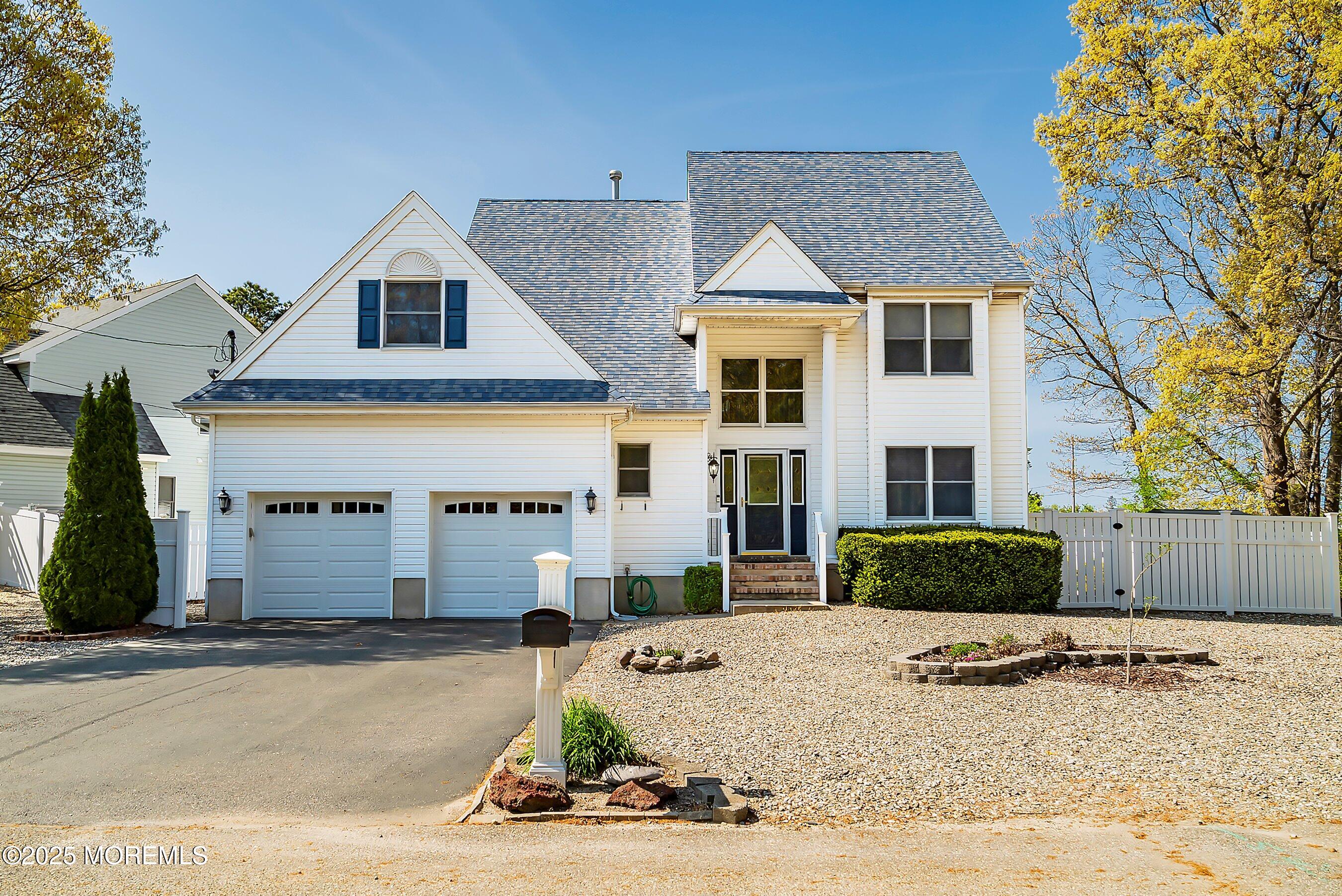 39 Ivy Court Bayville, NJ 08721 - Photo 19 of 33 a front view of a house with a yard and garage