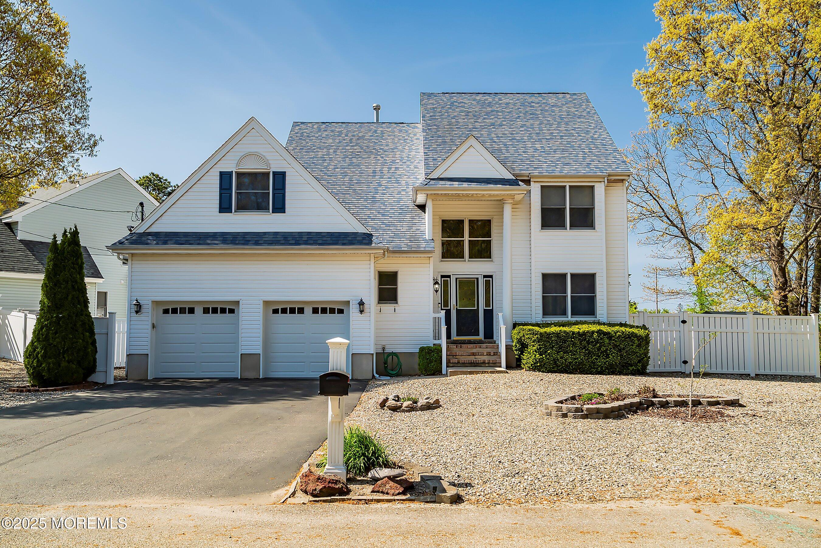 39 Ivy Court Bayville, NJ 08721 - Photo 20 of 33 a front view of a house with a yard and garage