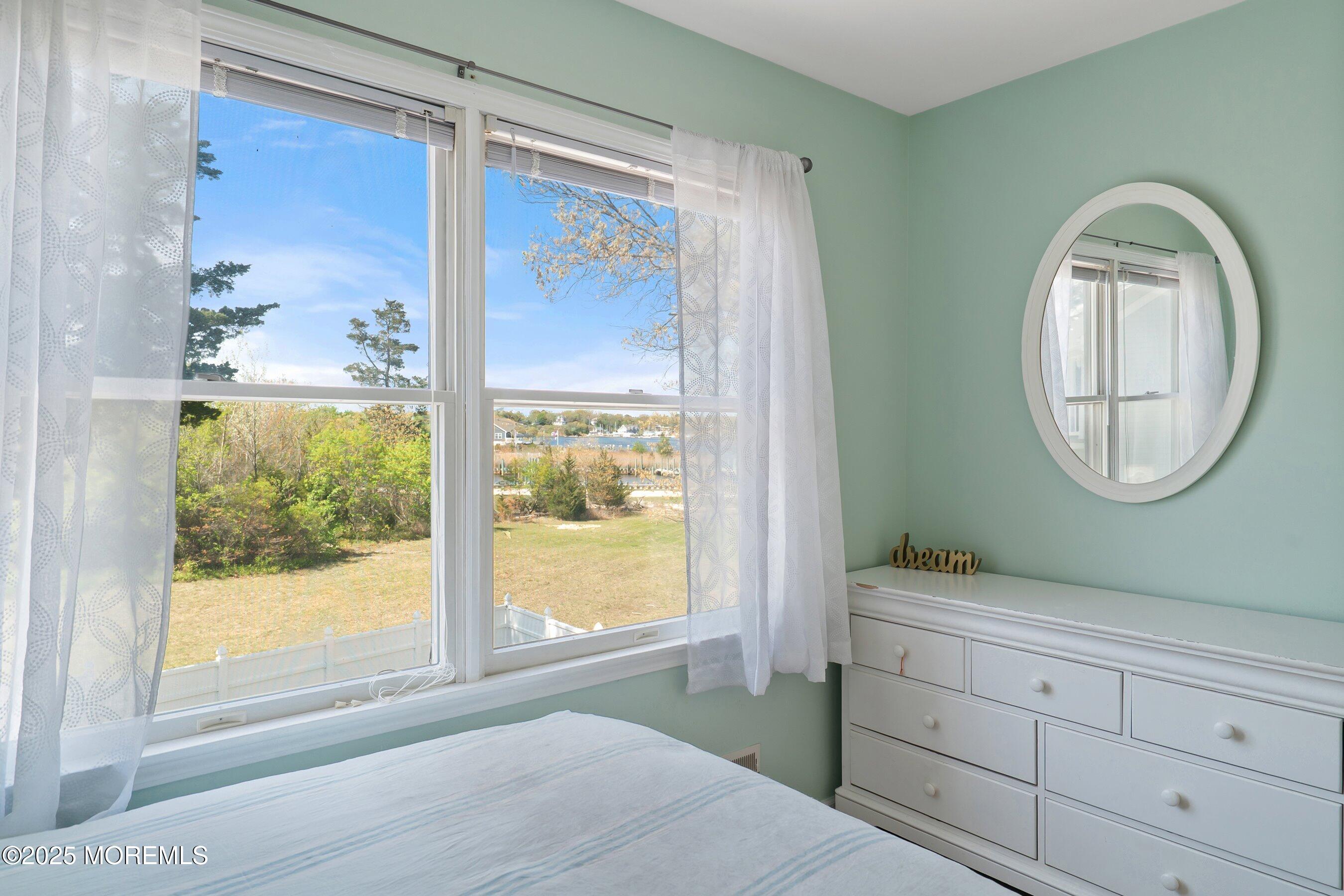 39 Ivy Court Bayville, NJ 08721 - Photo 23 of 33 a room with a mirror on the wall and a window