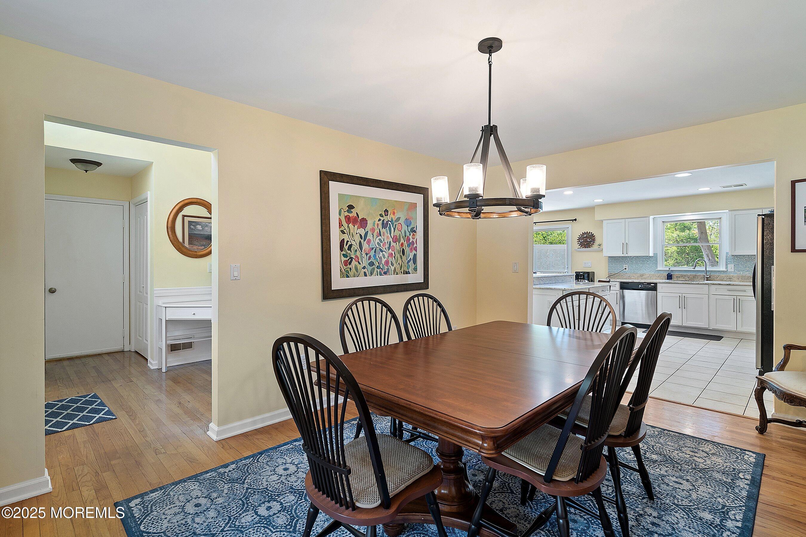 39 Ivy Court Bayville, NJ 08721 - Photo 3 of 33 a dining room with furniture a chandelier and wooden floor