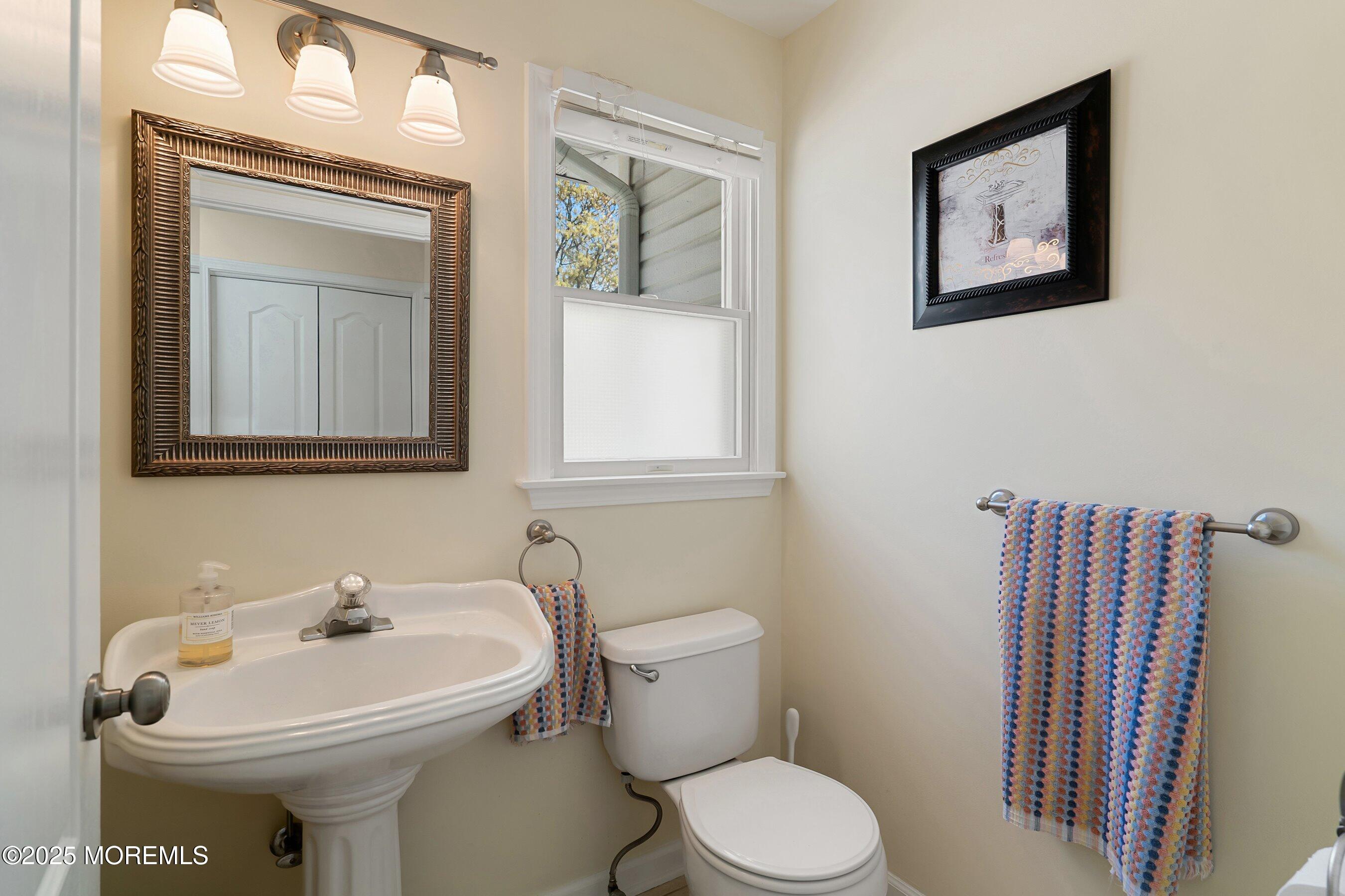 39 Ivy Court Bayville, NJ 08721 - Photo 32 of 33 a bathroom with a sink mirror and toilet