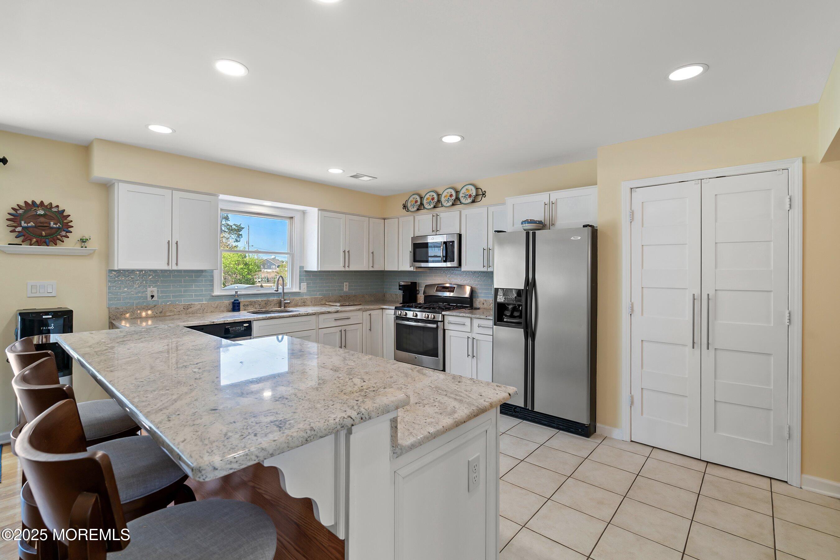 39 Ivy Court Bayville, NJ 08721 - Photo 6 of 33 a kitchen with a refrigerator a stove a sink and a counter