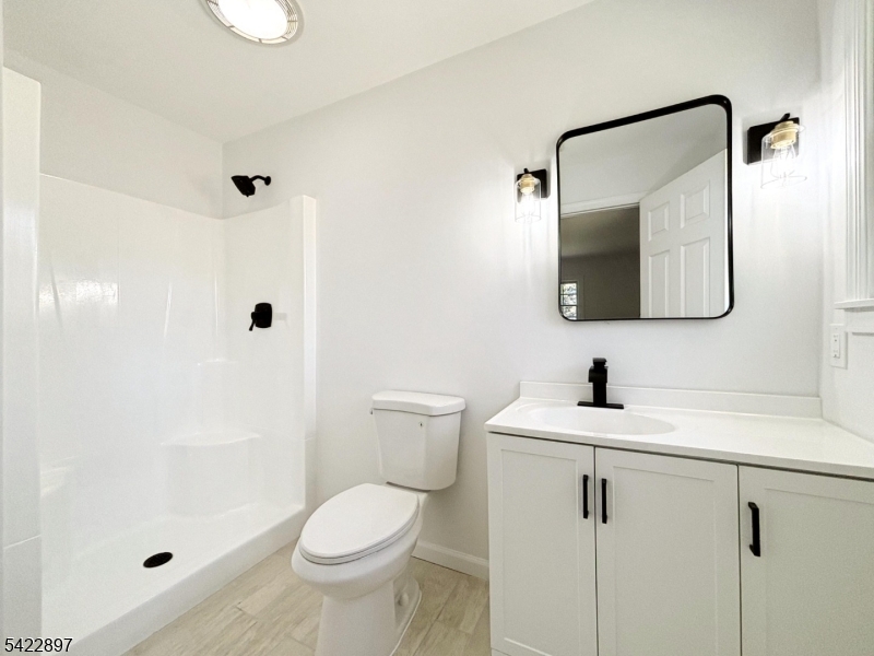 4 Baker Road Vernon, NJ 07461 - Photo 13 of 30 a bathroom with a sink a toilet and shower