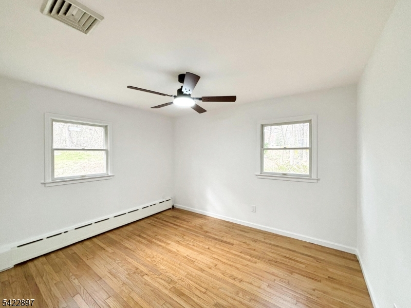4 Baker Road Vernon, NJ 07461 - Photo 14 of 30 a view of empty room with wooden floor and fan