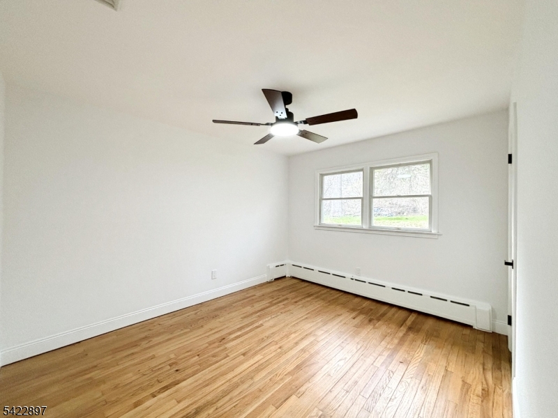 4 Baker Road Vernon, NJ 07461 - Photo 15 of 30 a view of a room with wooden floor and a ceiling fan