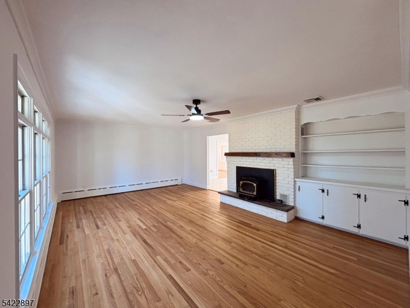 4 Baker Road Vernon, NJ 07461 - Photo 3 of 30 wooden floor fireplace and windows in an empty room