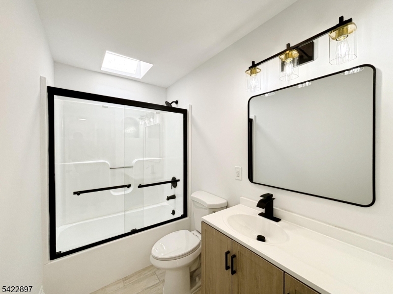 4 Baker Road Vernon, NJ 07461 - Photo 10 of 30 a bathroom with a sink mirror toilet and glass door