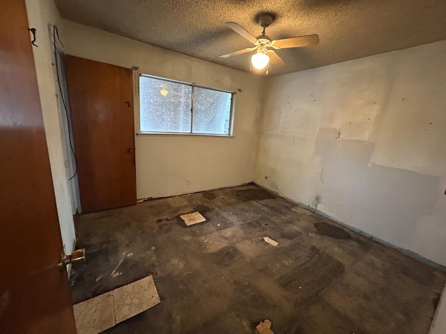 755 H Street Parlier, CA 93648 - Photo 18 of 22 a view of a workspace with wooden floor and a ceiling fan