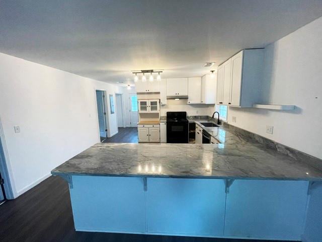4495 Calhoun Road Northeast Rome, GA 30161 - Photo 6 of 14 a kitchen with stainless steel appliances granite countertop a sink a stove counter space and cabinetry