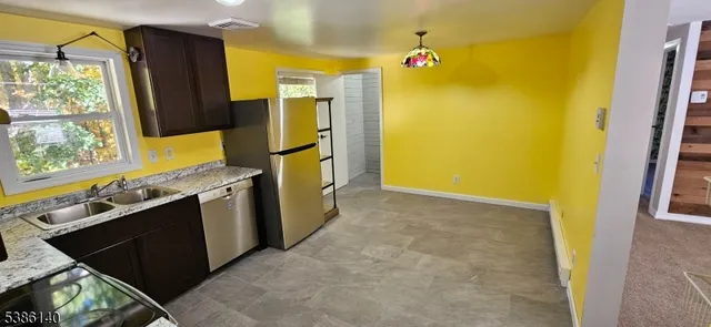 a kitchen with a sink appliances and cabinets