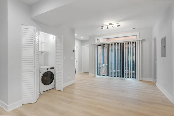 a view of a livingroom with wooden floor and a ceiling fan