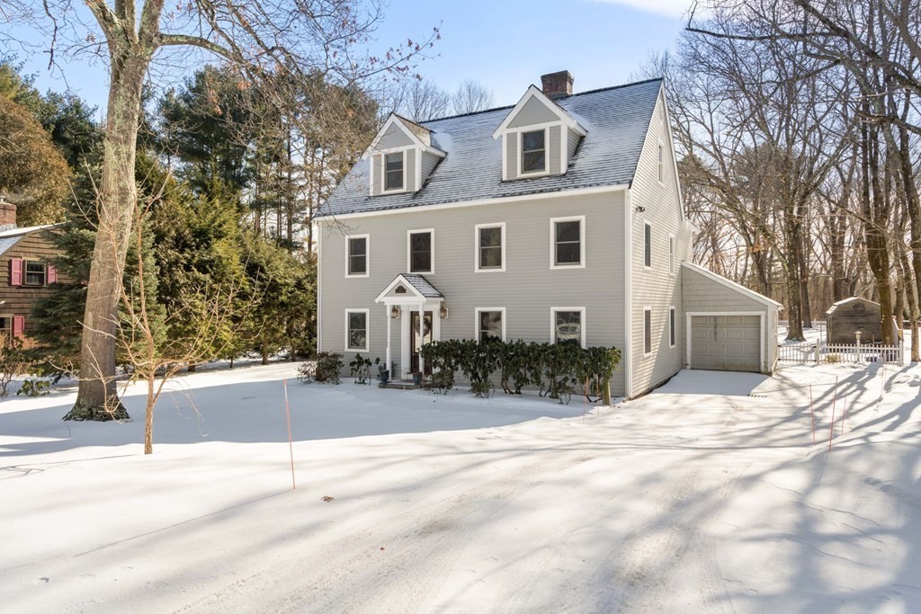 72 Fuller Brook Road Wellesley, MA 02482 - Photo 1 of 26 a view of a white house with a yard covered in snow
