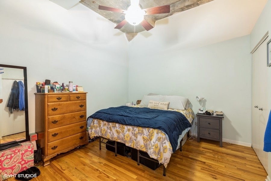 1070 West 15th Street, Unit 102 Chicago, IL 60608 - Photo 17 of 20 a bedroom with a bed and a dresser