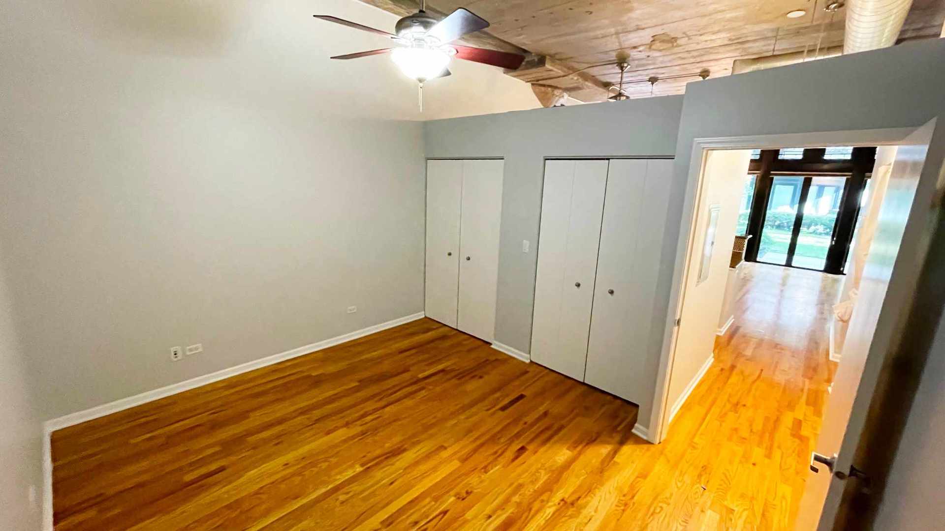 1070 West 15th Street, Unit 102 Chicago, IL 60608 - Photo 18 of 20 a view of a room with wooden floor and staircase