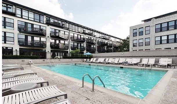 1070 West 15th Street, Unit 102 Chicago, IL 60608 - Photo 19 of 20 a view of a swimming pool with outdoor seating and a yard