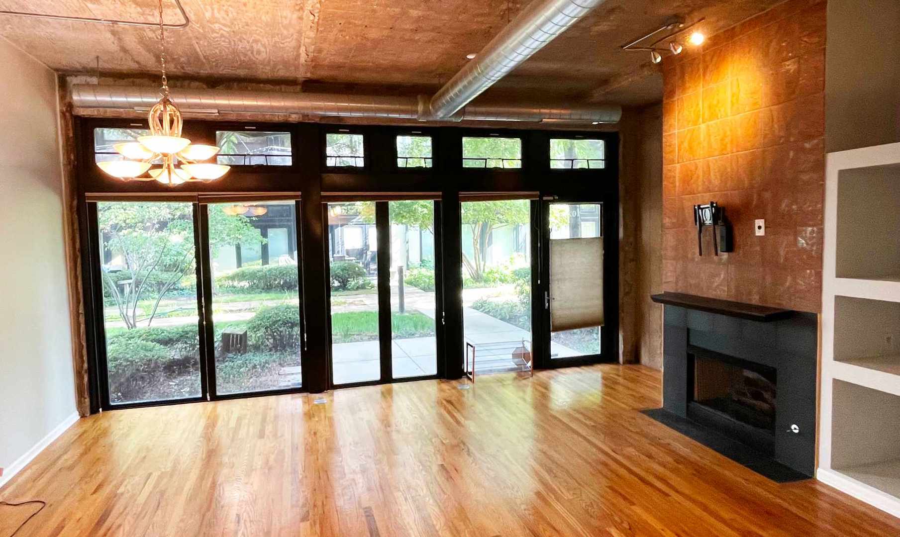 1070 West 15th Street, Unit 102 Chicago, IL 60608 - Photo 7 of 20 a view of an empty room with glass door and balcony
