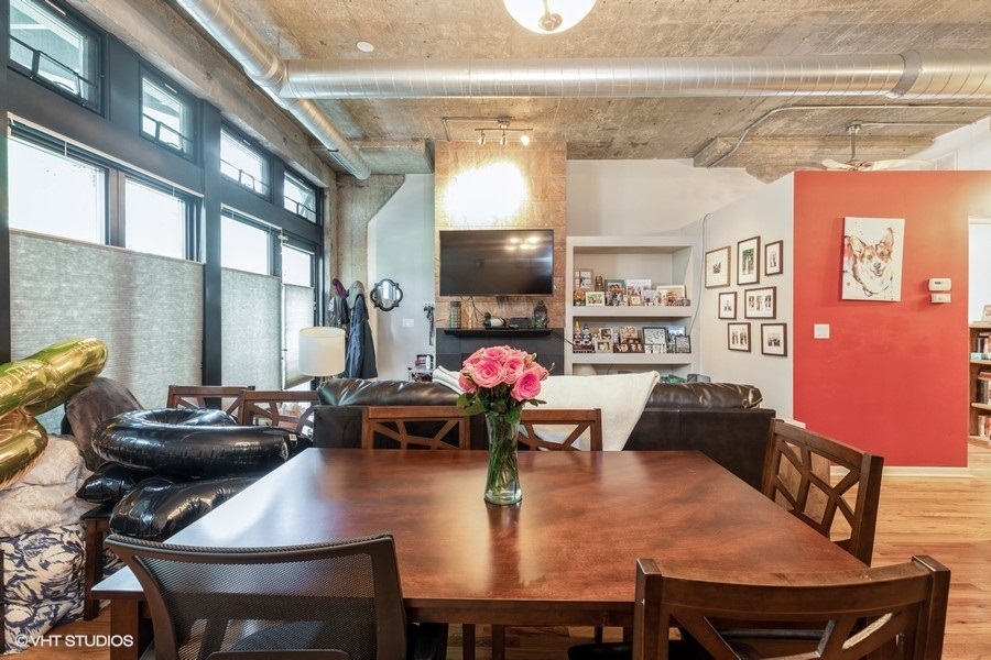 1070 West 15th Street, Unit 102 Chicago, IL 60608 - Photo 10 of 20 a view of a dining room with furniture and chandelier