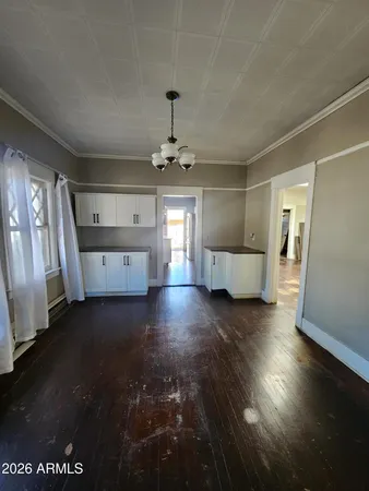 a view of an empty room with a fireplace and a window