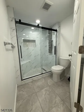a bathroom with a shower and a toilet