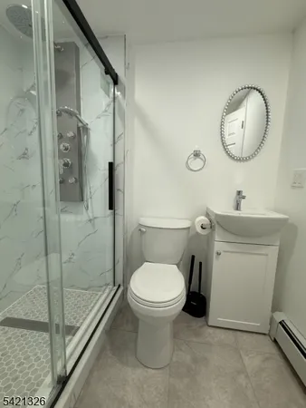 a bathroom with a toilet a sink and a mirror