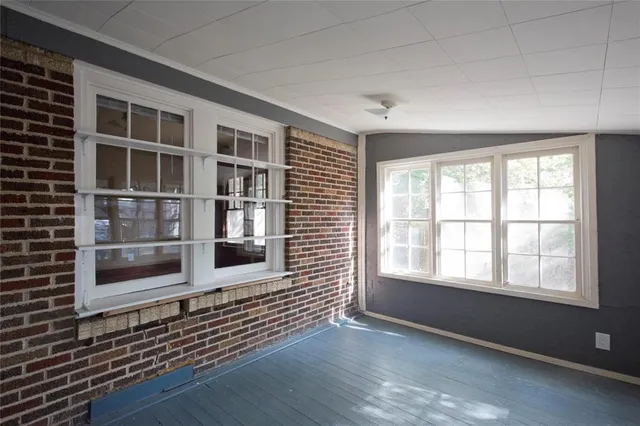 a view of a house with a yard and tree