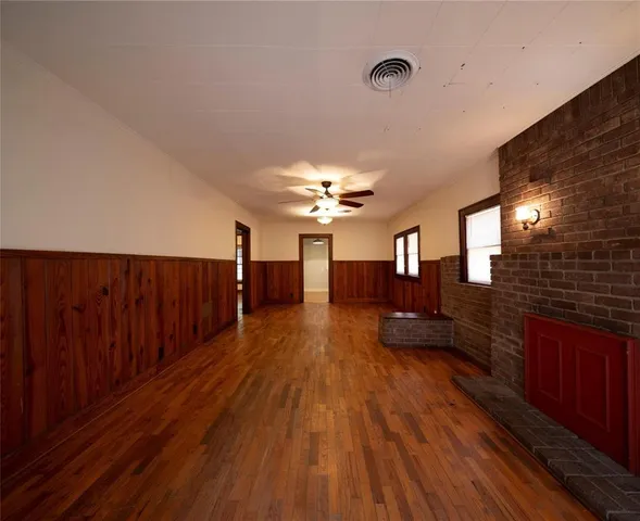 a view of a room with wooden floor