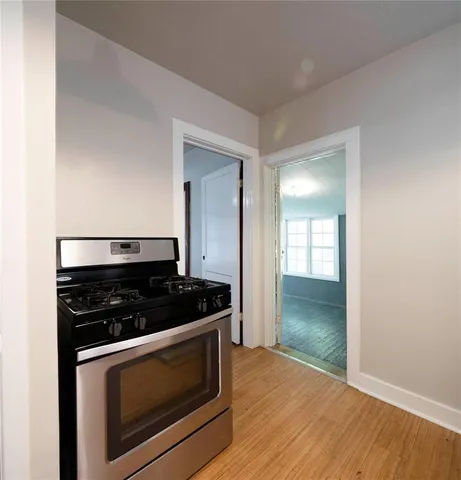 a kitchen with granite countertop a stove and a wooden cabinets