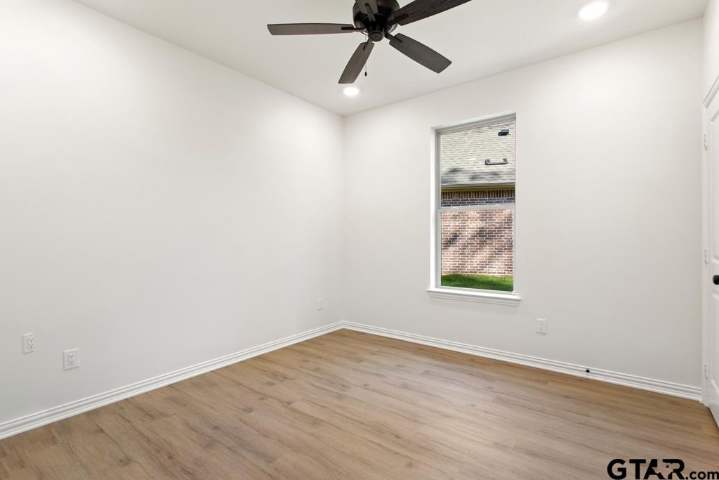 496 Preston Rdg Drive Tyler, TX 75703 - Photo 15 of 34 an empty room with wooden floor and windows