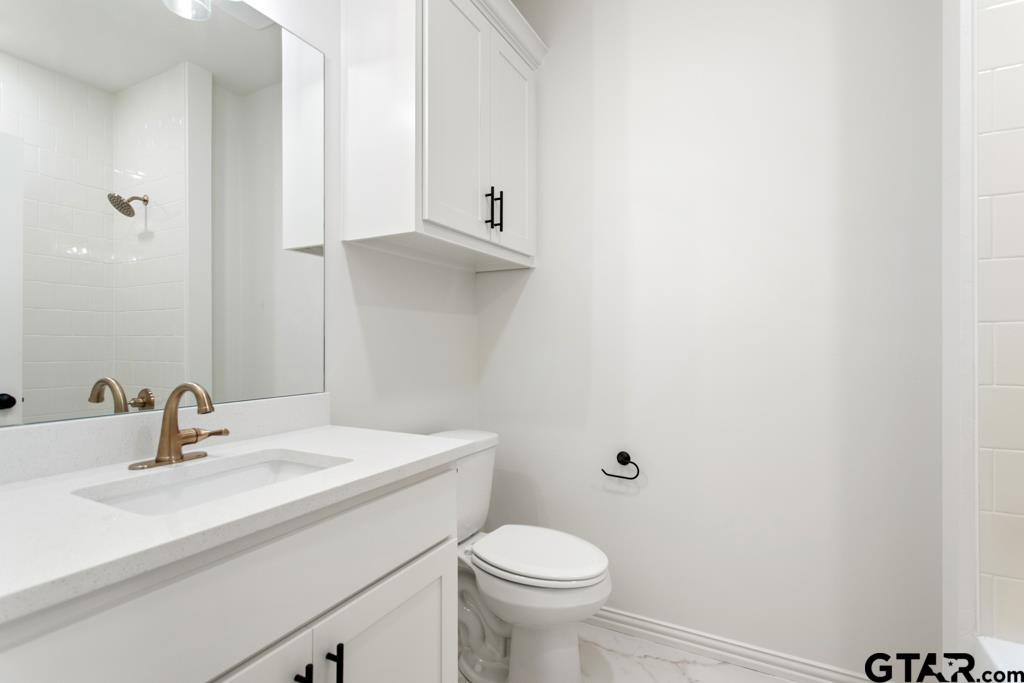496 Preston Rdg Drive Tyler, TX 75703 - Photo 16 of 34 a bathroom with a sink toilet and vanity